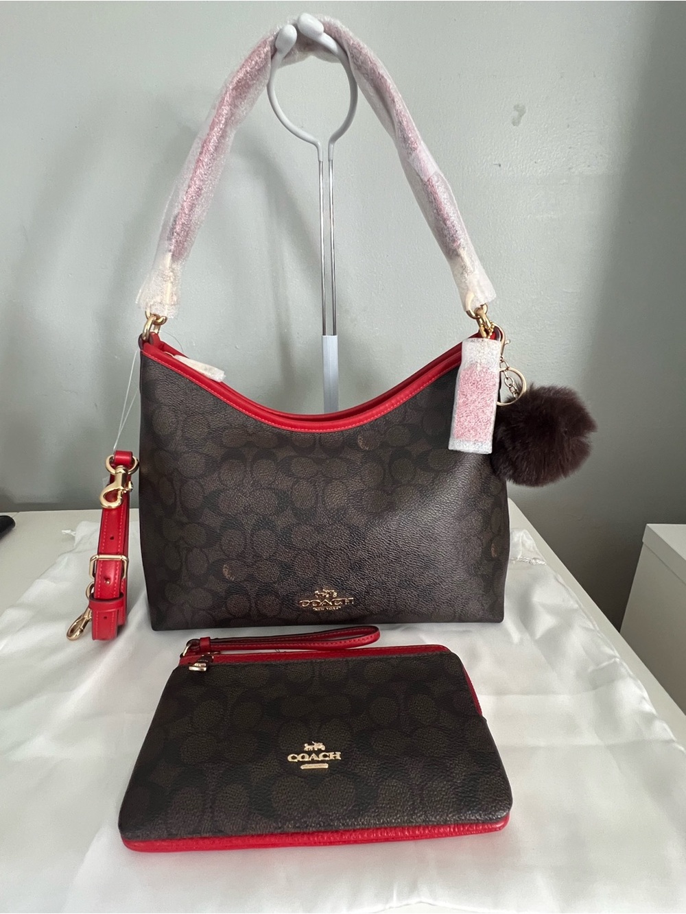 Coach Brown Signature Canvas Shoulder Bag with Red Trim and Pom Charm